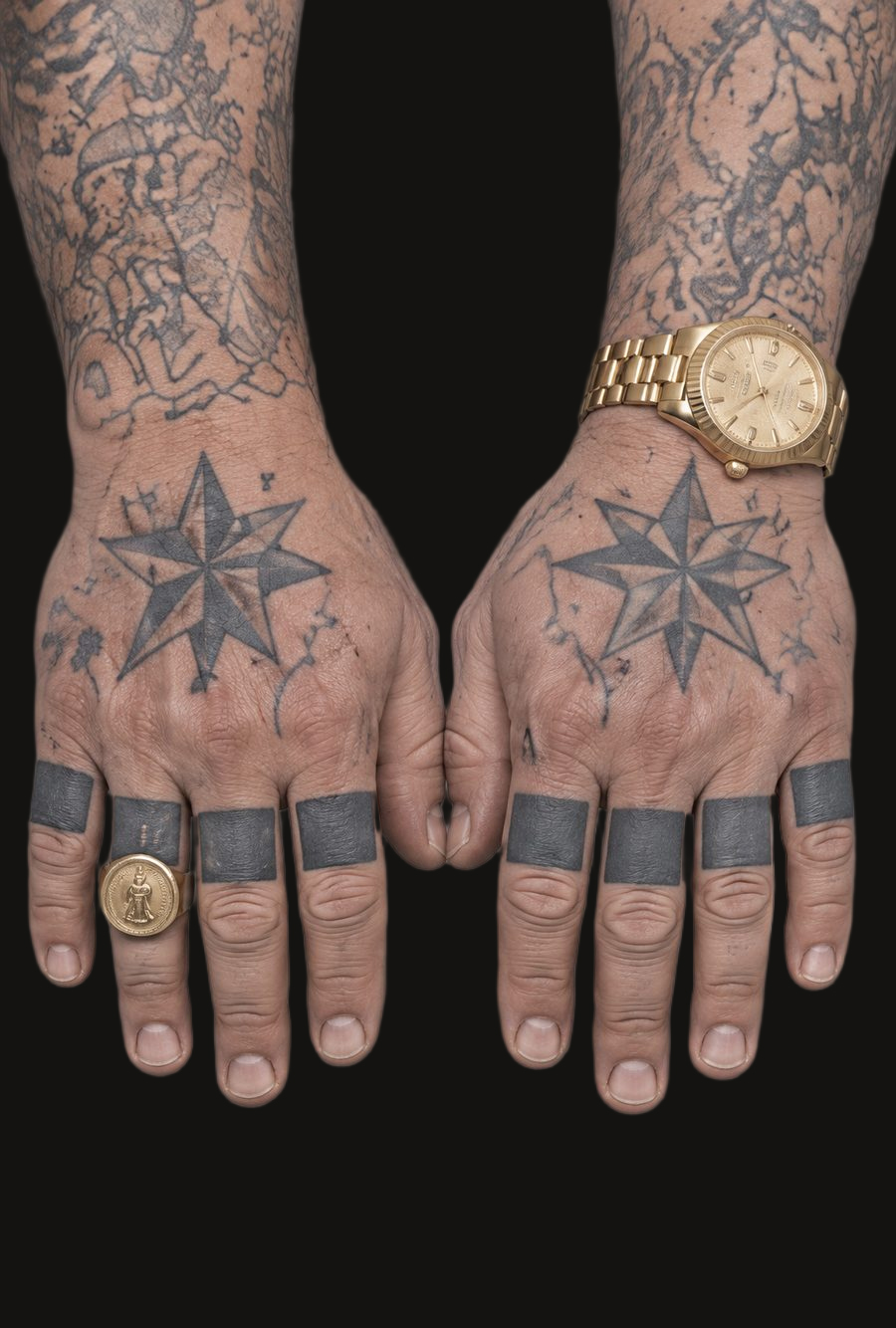 Yaroslav's tattooed hands: a black ring tattooed on every finger and an eight-pointed star on the back of each hand